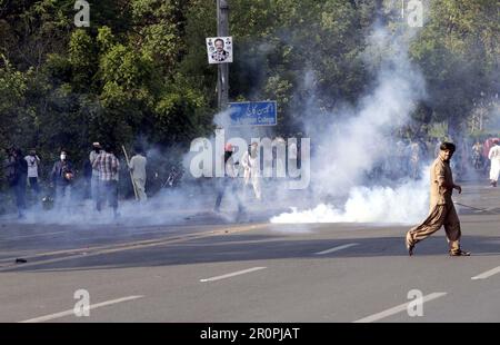 Police officials restore baton charge, fired tear gas shells and used water canon to repel protesters during protest demonstration of Tehreek-e-Insaf (PTI) against the arrest of PTI Chief Imran Khan from the premises of Islamabad High Court, at Mall road in Lahore on Tuesday, May 9, 2023. Stock Photo