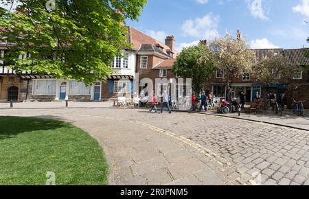 YORK, UK - MAY 9, 2023.  Tourists and locals enjoying hot weather at the outdoor tables of cafes in the York Minster area of York, UK Stock Photo