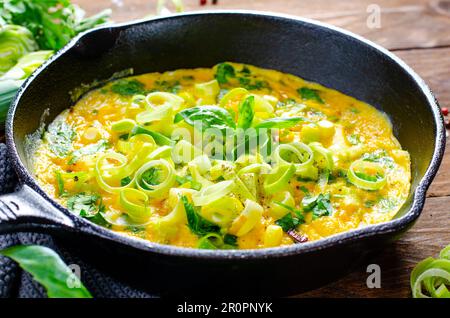 Omelette with Leek and Herbs, Delicious Snack or Breakfast on Wooden Background Stock Photo