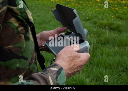 Pilot Operating DJI Mini 3 Pro Drone With DJI RC Stock Photo