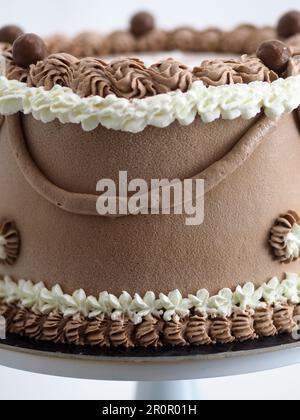 elegant beige brown frosted icing cake macro close up isolated on white background for celebration Stock Photo