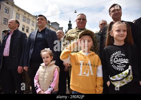 Lviv, Ukraine. 06th May, 2023. A boy salutes during the celebration of Lviv Day on Rynok Square. This weekend, Lviv celebrated the 767th anniversary of the founding of the city. Because of the Russian-Ukrainian war, there were no big celebrations. The events were limited to the raising of the city's flag, the removal of the flags of the Ukrainian formations fighting against the Russian aggressors, and the marching of the honour guard. Credit: SOPA Images Limited/Alamy Live News Stock Photo