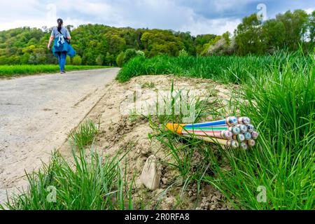 Fibre optic cable, freshly laid along a country lane, provision of fast internet in rural areas, Mülheim an der Ruhr, NRW, Germany Stock Photo