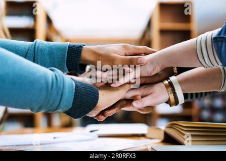 Straight As here we come. a group of students stacking their hands on top of each other. Stock Photo