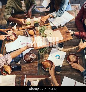 Having a productive lunch. High angle shot of a group of creative workers out on a business lunch. Stock Photo