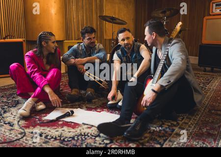 Young musicians practising the song in rehearsal room. High quality photo Stock Photo