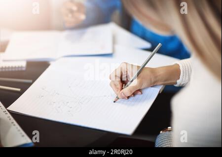 Planning for her successful future. Closeup shot of a university student writing notes in her book. Stock Photo