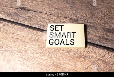 Set smart goals symbol. Concept words Set smart goals on white notebook. Beautiful wooden background. Business and Set smart goals concept. Copy space Stock Photo