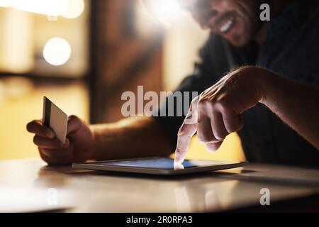 Accept. an unrecognizable male designer using his digital tablet to shop online while working in the office. Stock Photo