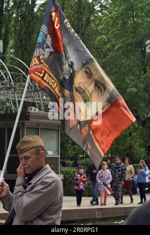 A participant holds a portrait of Joseph Stalin on a flag in Koltsovsky
