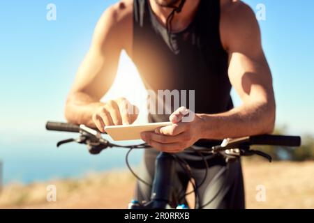 If youre passionate about something, why not write about it. a man using his cellphone while out for a ride on his mountain bike. Stock Photo