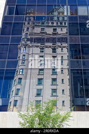 Plaza Hotel reflected in the Solow Building's curved glass facade, in Midtown Manhattan. Stock Photo