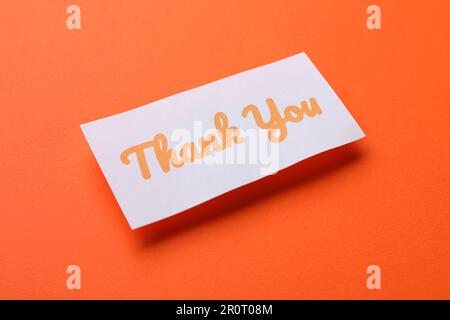 Note with phrase Thank You on orange background Stock Photo