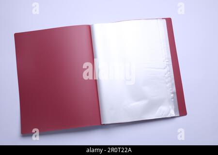 File folder with punched pockets and paper sheets isolated on white, top view Stock Photo