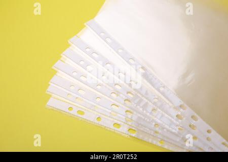 Punched pockets on yellow background, flat lay Stock Photo - Alamy