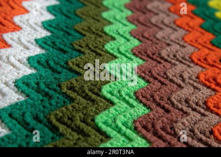 close-up of grandma's retro zigzag striped blanket, crocheted or knitted, grandma's house, cozy and warm Stock Photo