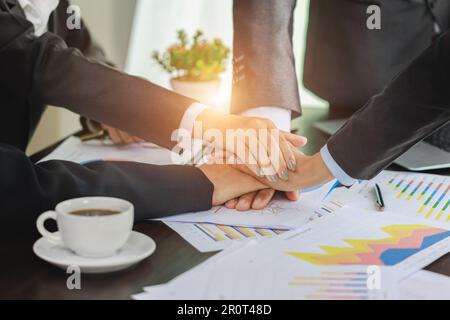 Business people put their hands together unity and teamwork concept Job success. Stock Photo