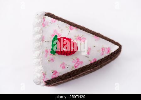 Chocolate and raspberry cake pincushion with a strawberry on top Stock Photo