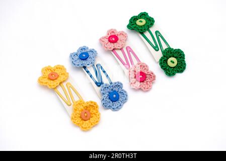 Hair clips with multicolored flowers woven with corchet Stock Photo