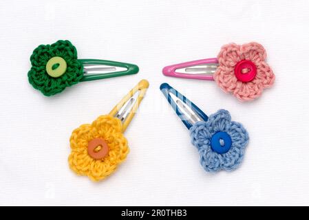 Hair clips with multicolored flowers woven with corchet Stock Photo