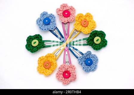 Hair clips with multicolored flowers woven with corchet Stock Photo