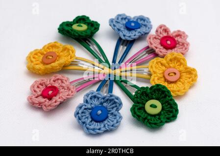 Hair clips with multicolored flowers woven with corchet Stock Photo