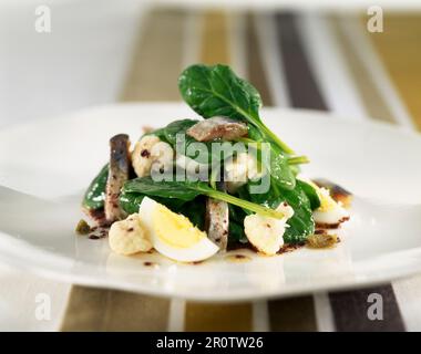 cauliflower, spinach and mackerel fillet salad with dressing Stock Photo