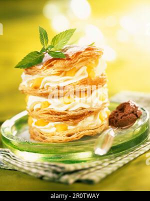 Mousse and peach in flaky pastry Stock Photo