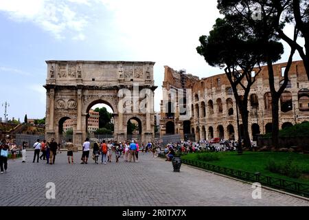 Tourists visiting the Arch of Constantine and Colosseum in Rome Italy Stock Photo