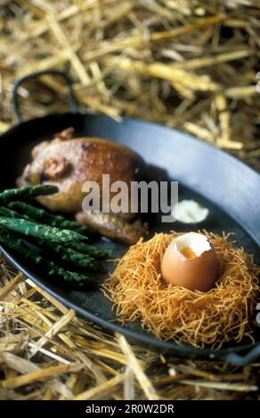 Honey-glazed spring chicken and a soft-boiled egg Stock Photo