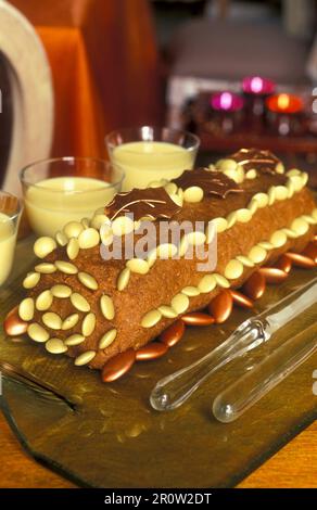 Moist coffee and nut cake decorated with almonds Stock Photo