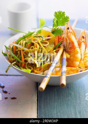 Vegetables and noodles sauteed in a wok,shrimps and pineapple Stock Photo
