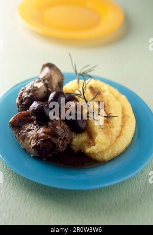 Rabbit ,olive and rosemary stew with polenta Stock Photo