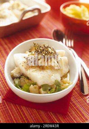 Half-cooked cod with medium-dry goat's cheese and potato and citrus fruit salad Stock Photo