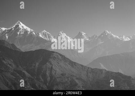 Beautiful Himalayan landscape in morning haze, black and white. Snow-capped peaks and Himalaya mountains, monochrome. Himalayas nature. Stock Photo