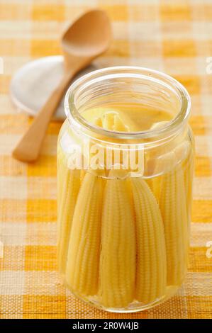 Jar of mini corn on the cobs Stock Photo