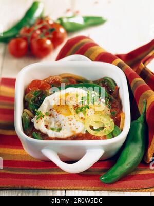 Piperade with fried eggs Stock Photo