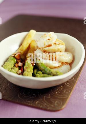 Pan-fried scallops with with green asparagus and balsamic sauce Stock Photo