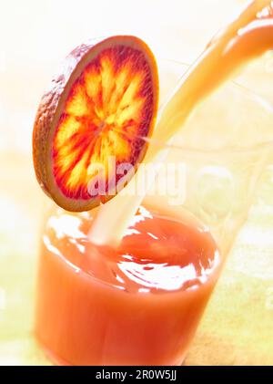 Pouring a glass of blood orange juice Stock Photo