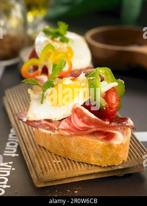 Chistorra and fried quail's egg open sandwich Stock Photo