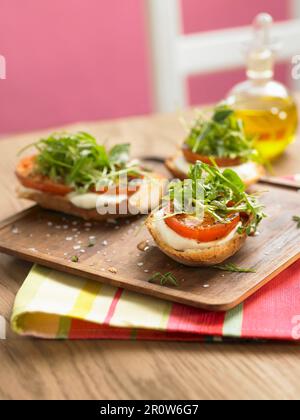 Sliced farmhouse loaf with tomatoes, rocket lettuce, parsley and coriander Stock Photo