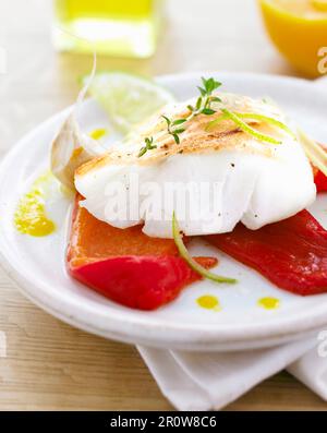 Piece of cod with red peppers and garlic Stock Photo