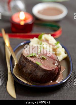 Roast bison with Grand veneur sauce, mixed mashed potatoes and celeriac Stock Photo