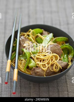 Beef and sugar pea stir-fry Stock Photo