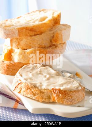 Cream cheese on sliced bread Stock Photo