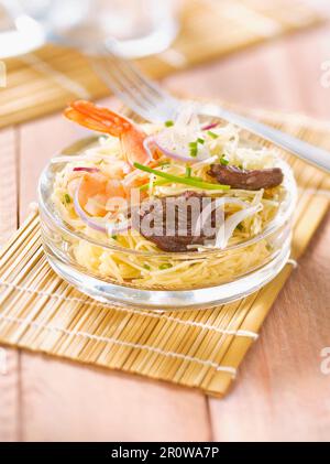 Thai-style sauteed shrimp and caramelized beef noodle salad Stock Photo