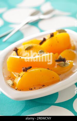 Peach fruit salad with cloces and cardamom Stock Photo