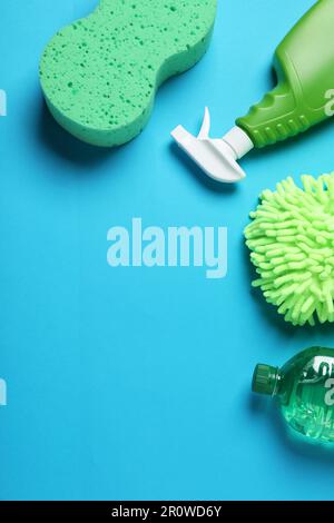 Flat lay composition with car cleaning products on light grey table ...
