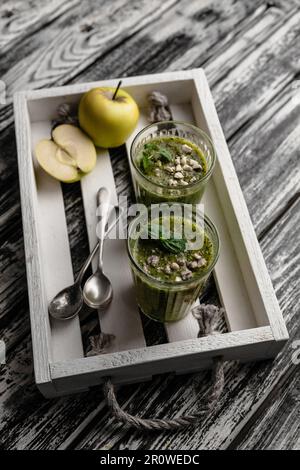 Delicious detox smoothie in glasses on rustic wooden tray Stock Photo