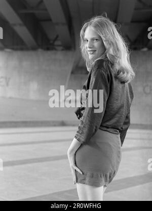 young slim pretty natural blonde female poses for portrait below an